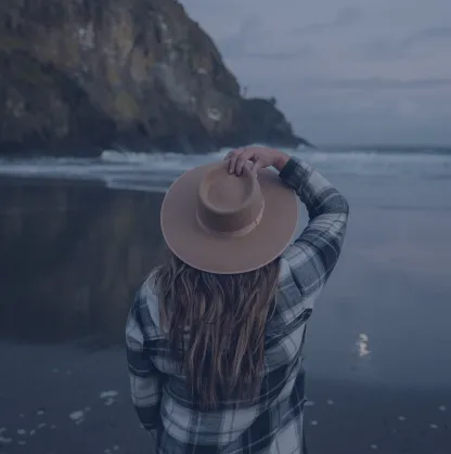 Girl in a hat on the background of the sea