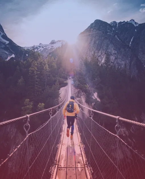 A man running on a suspension bridge